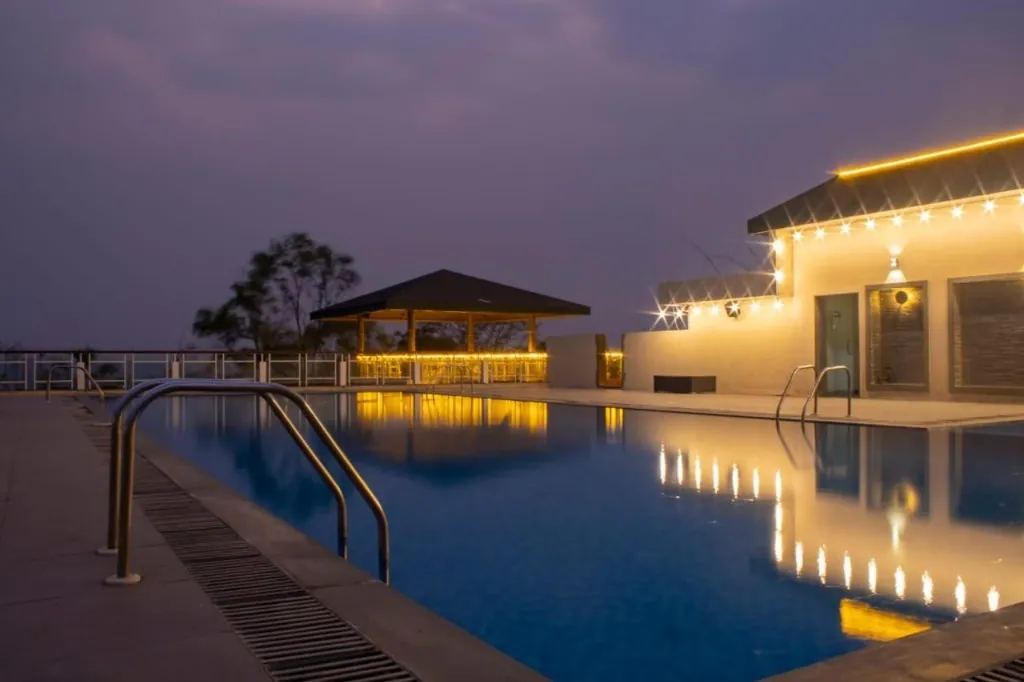 The Cliff Club Premium Swimming Pool at Night - Paranjape Forest Trails Bhugaon Township Luxury Amenities Pune